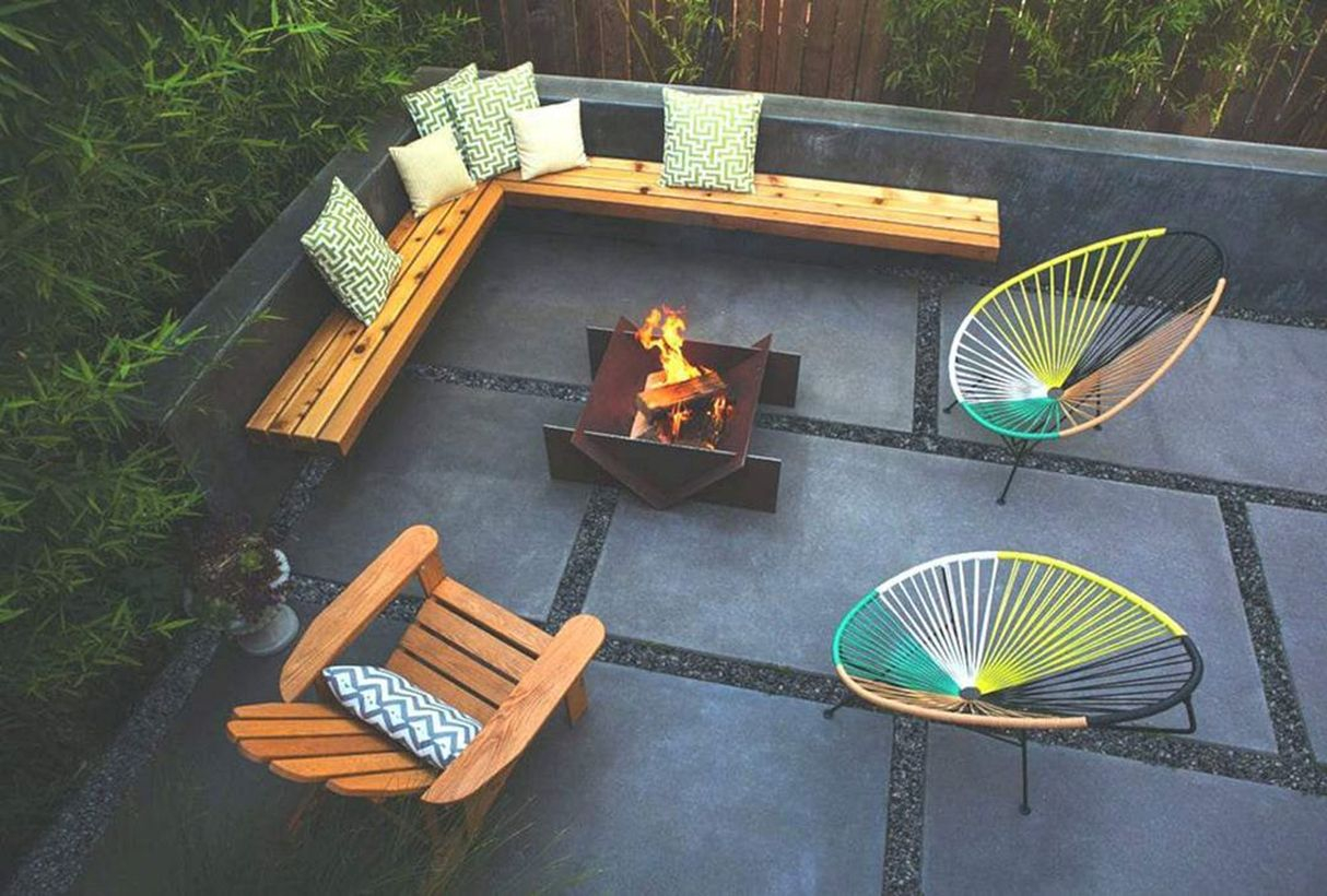 Modern fire pit with wooden pallet chair and iron chair