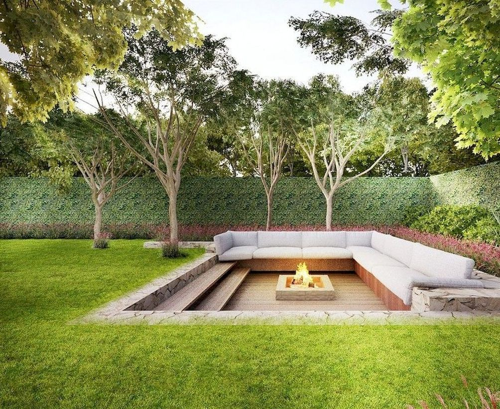 Modern square fire pit and white sofas