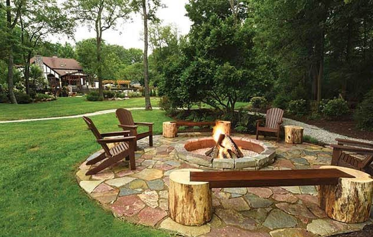 Outdoor fire pit with chunks of trees to sit