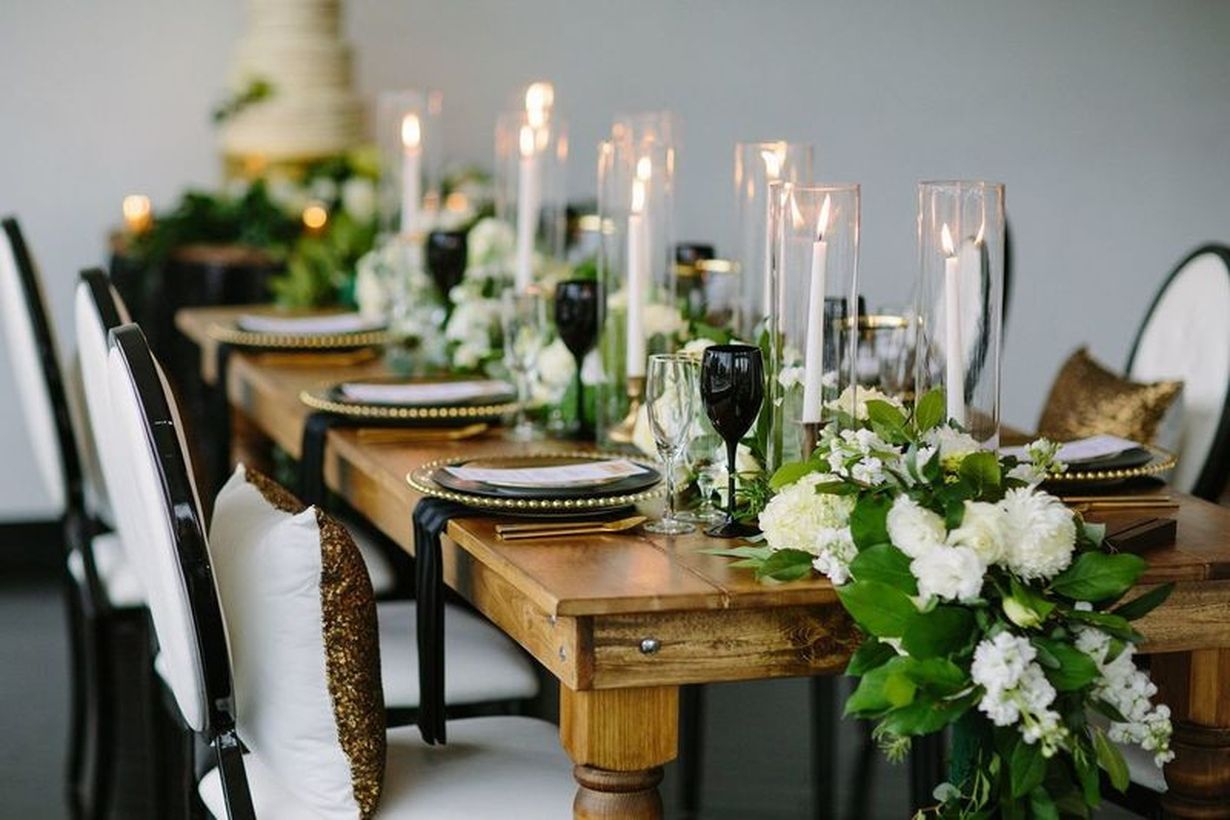Romantic wedding decoration with monochromatic flowers and taper candles to complete the look
