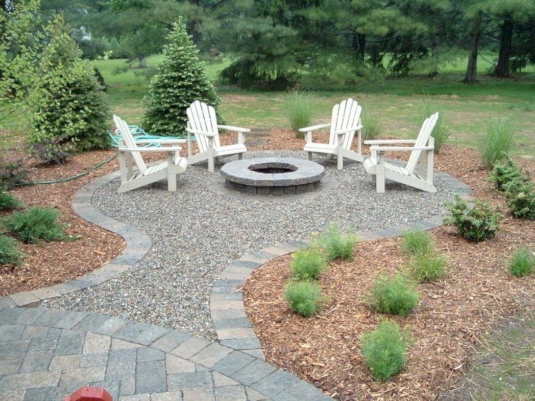 Round stone fire pit and white wooden chair
