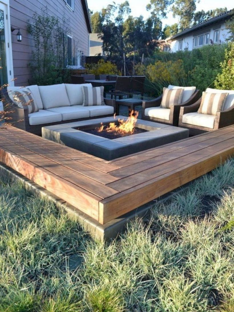 Square fire pit with white sofas and striped sofa cushions