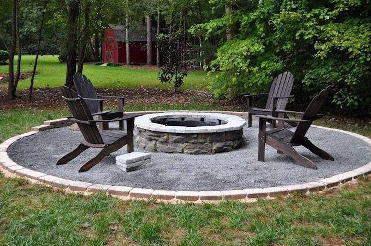 Stone fire pit with black wooden chair