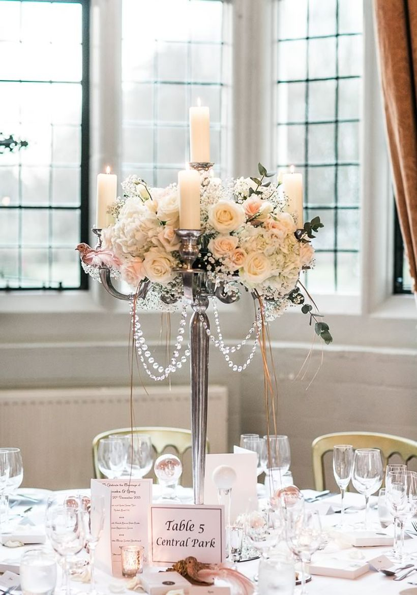 Wedding decoration silver candelabra to create tables to complement their venue’s existing style with elegant roses and garlands of crysrtal beads