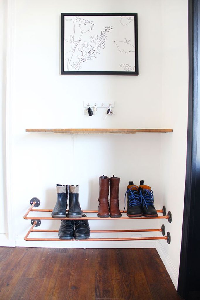 A creative shoes storage idea for a small bedroom with floating shelves with iron materials to organize your shoes storage