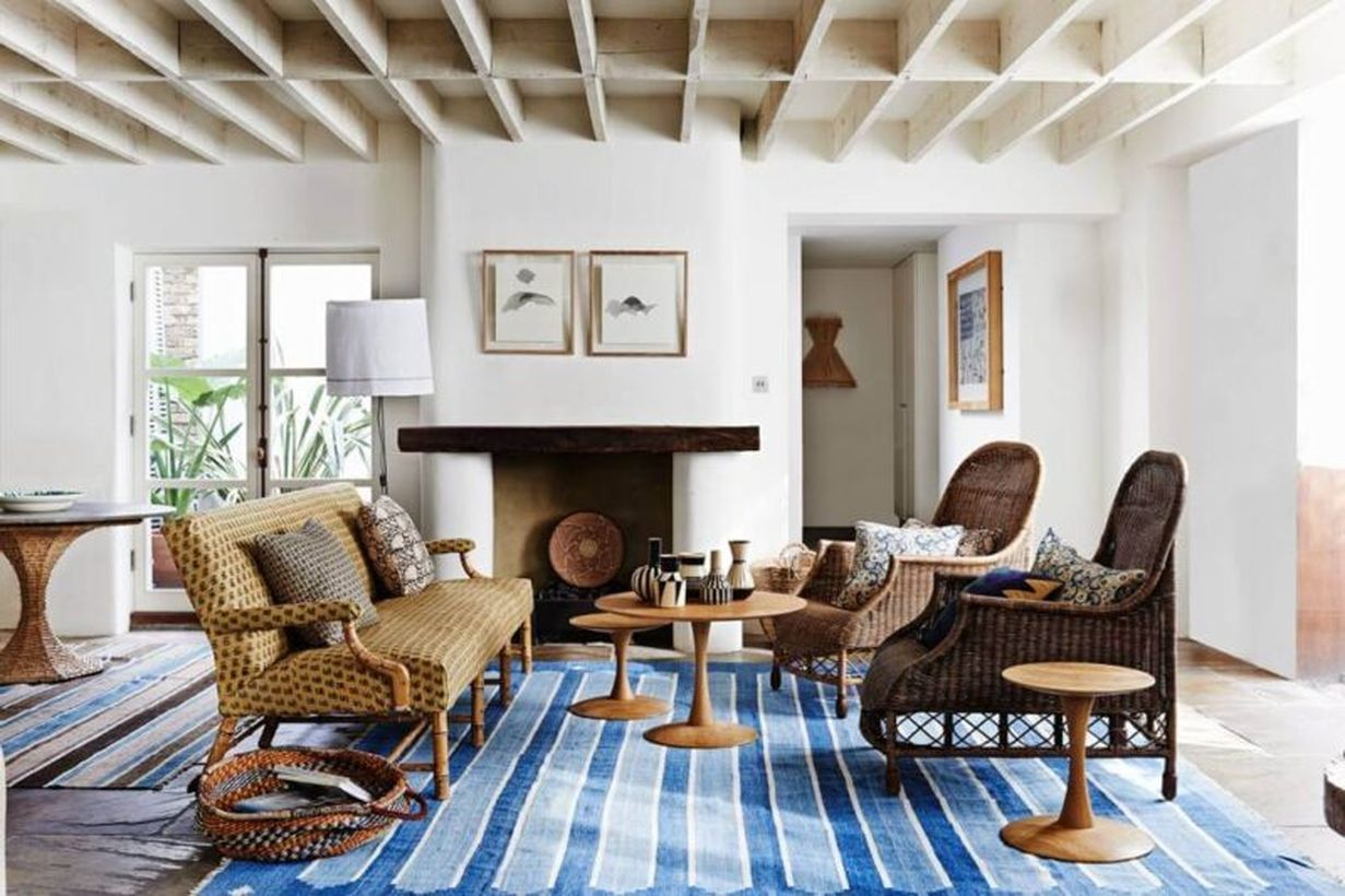 An awesome living room with round wooden table, brown sofa, white walls for wonderful decor
