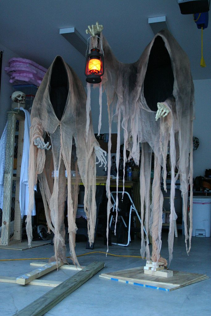 An awesome outdoor decorating for halloween with haunting hooded ghouls to complete your garden decoration