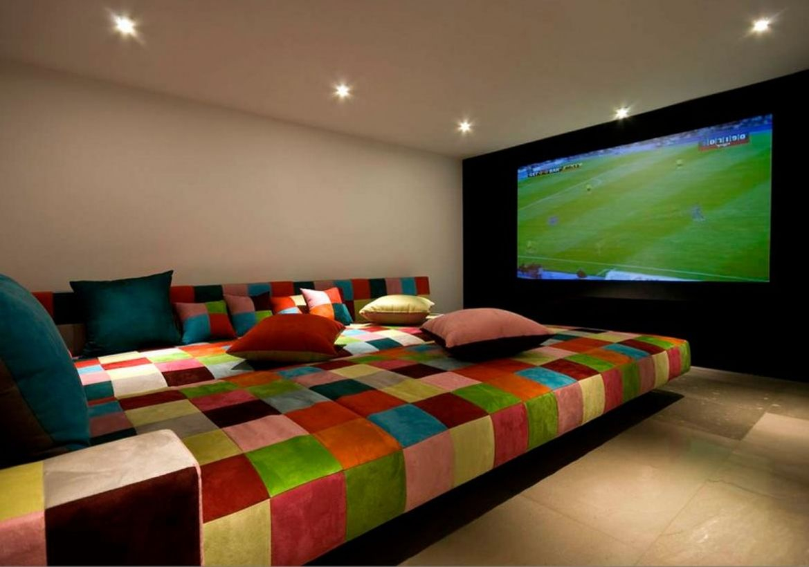 Basement with colorful sofa and big tv