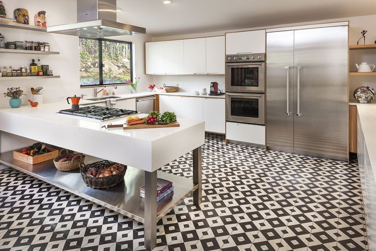Black and white small patteren kitchen-tile floor with white cabinet and simple white table