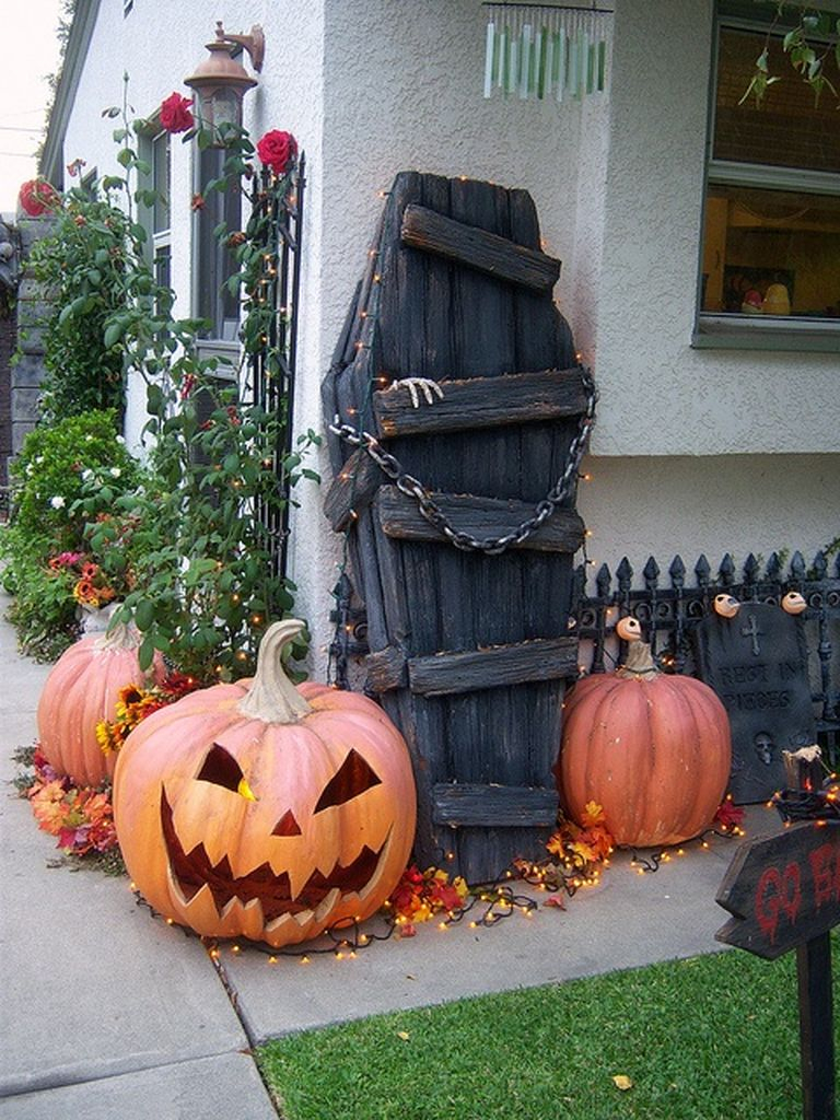 Captivating outdoor decorating for halloween with cryptic coffin combined with scary pumpkins to complete your outdoor decoration