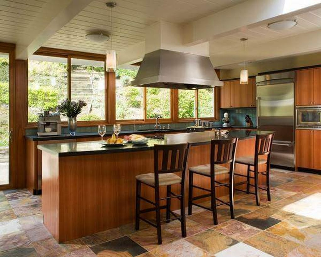 Classic kitchen flooring with wooden island table, wooden cabinet and wooden chairs