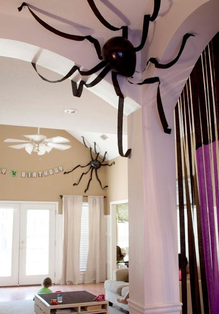 Creative indoor home decoration with black balloons and crepe paper spiders to perfect your halloween decorations