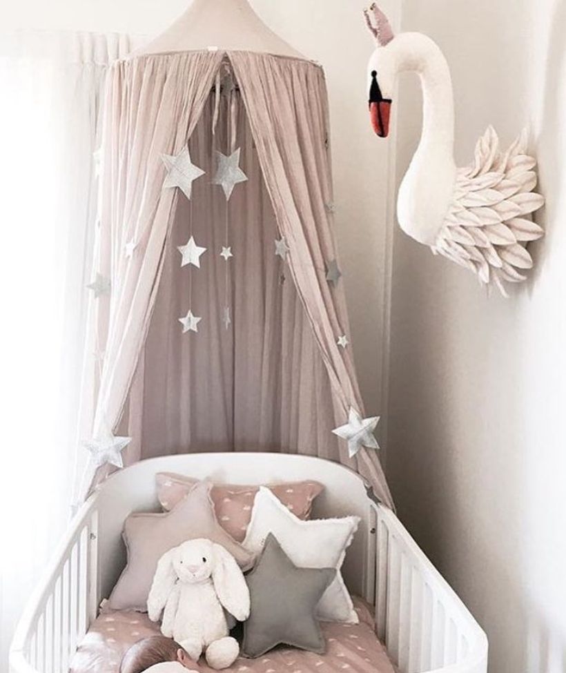 Cute-baby-girls-nursery-room-with-goose-accents-for-wall-decorations-and-star-shaped-pillows-so-baby-is-comfortable-while-sleeping