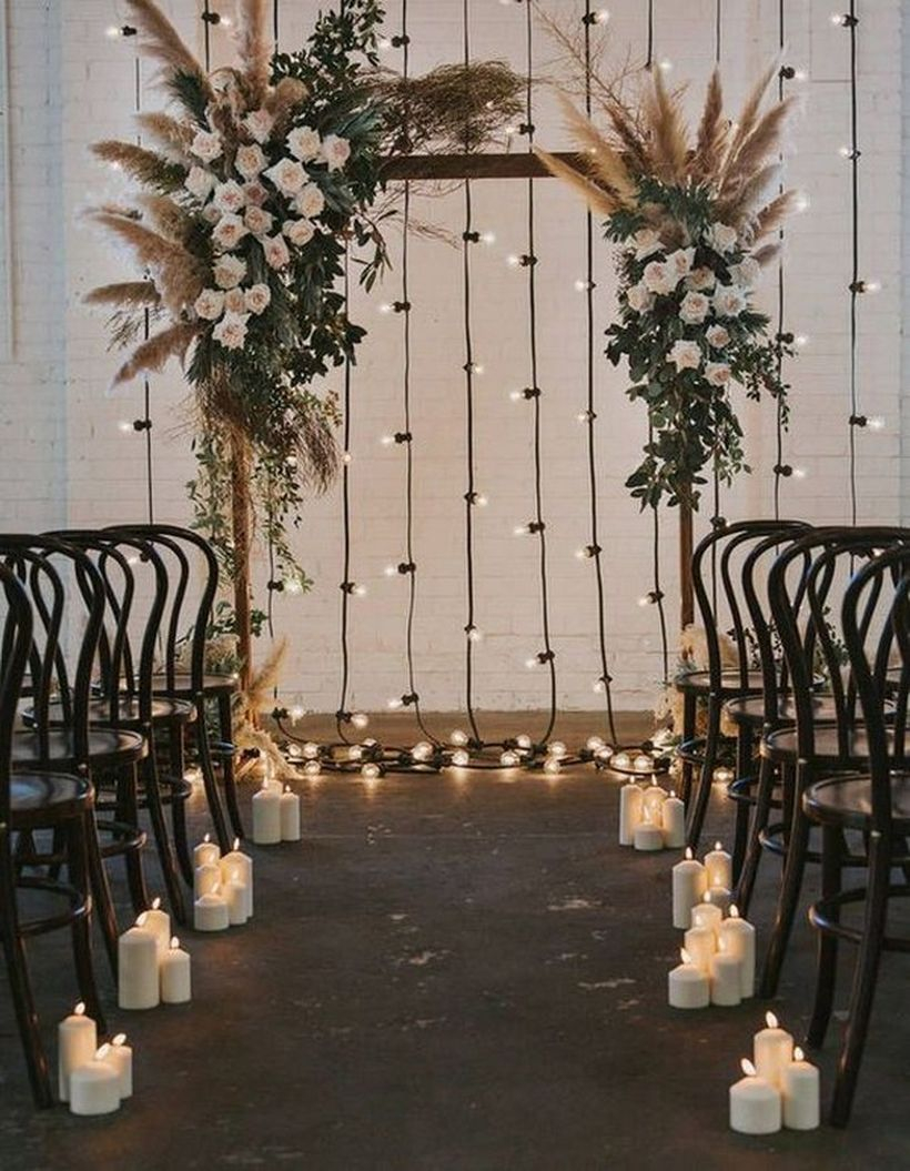 Diy bohemian wedding arch with cendle lights and white flowers decoration
