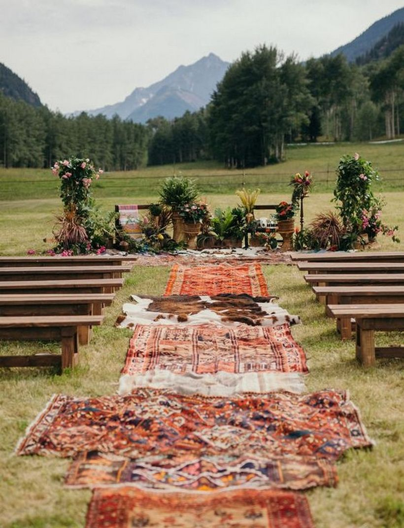 Diy outdoor boho wedding ceremony with wooden chirs and carpet