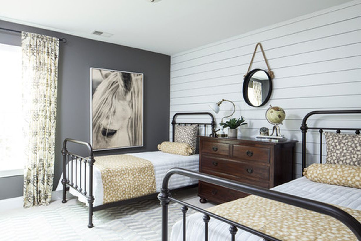 Easy bedroom with white bed, white wooden wall, and black iron bedstead to look impressive