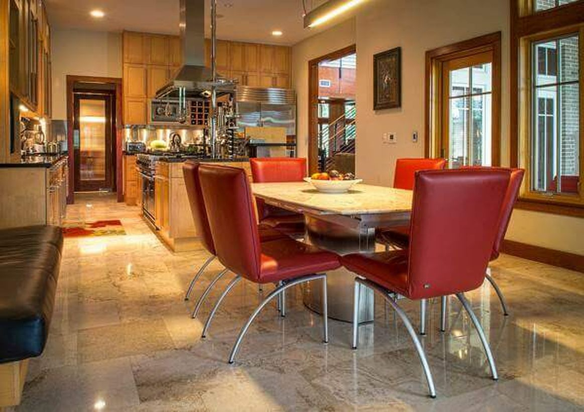 Elegant beige kitchen flooring with modern cabinet, red chairs and square wooden