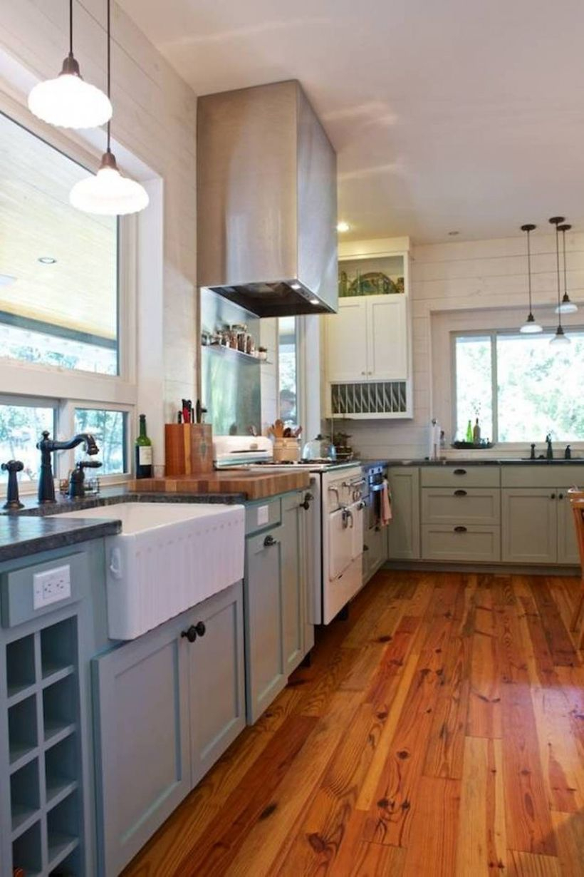 Hardwood floor kitchen style with gray cabinet, white walls and hanging light