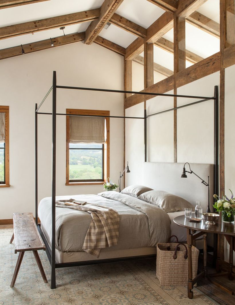 Incridible bedroom with black iron bedstead, gray bed, long square wooden chairs to look good