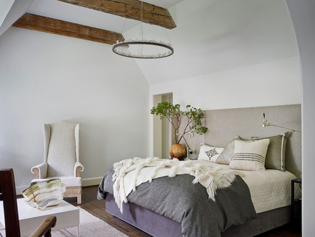 Intresting bedroom with white bed, small square white table and round wooden candle lamp to look unique