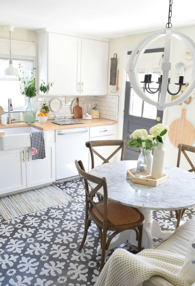 Kitchen floor white pattern in gray color combined with white cabinets, white round tables, wooden chairs and white round lamps