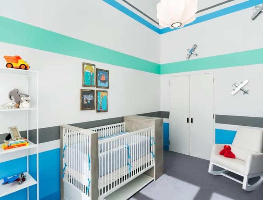 Large-baby-boys-nursery-room-with-white-and-blue-color-toy-airplane-attached-to-the-wall-and-tiered-storage-to-store-toy