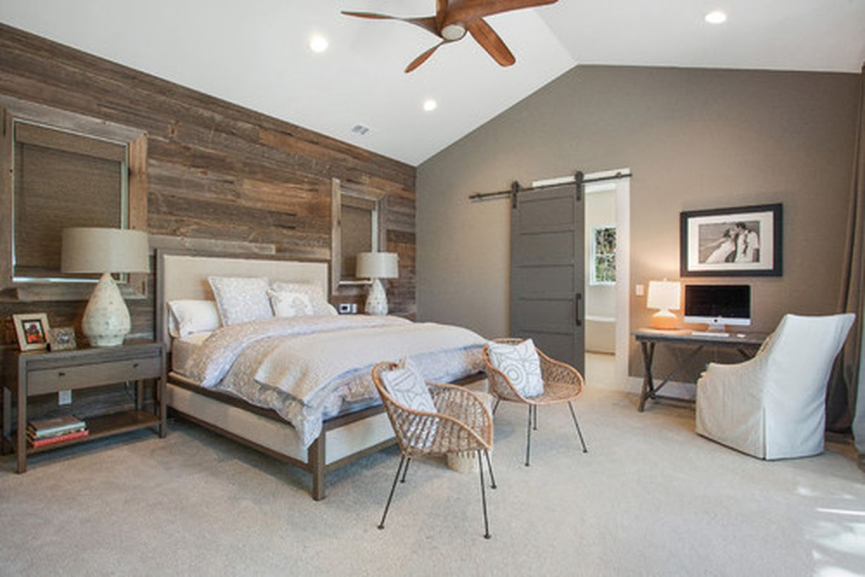 Simple bedroom with white bed, rattan chairs, and wooden wall decoration ideas