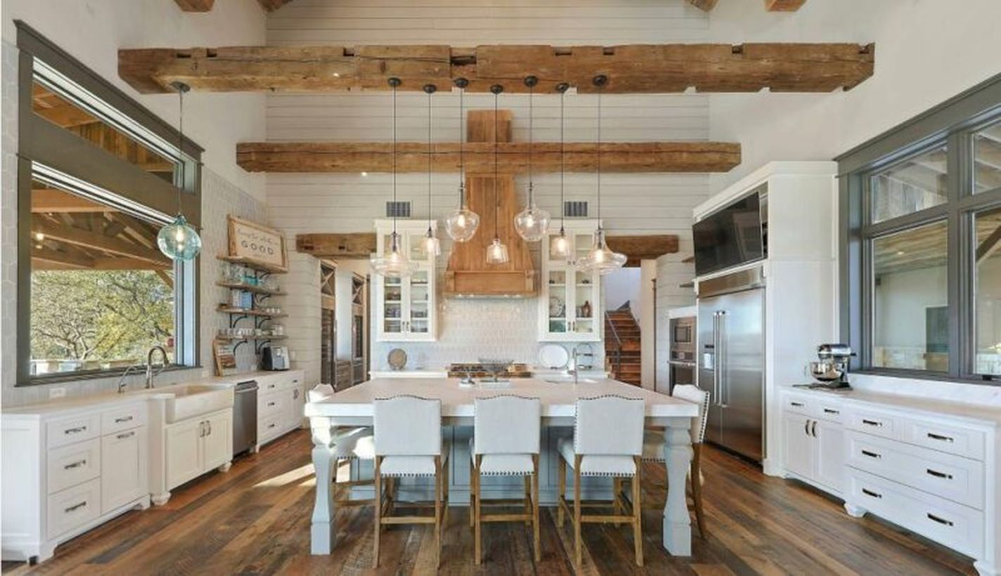 Stunning white kitchen with white island table, white cabinet and hanging lampis for beautiful decoration