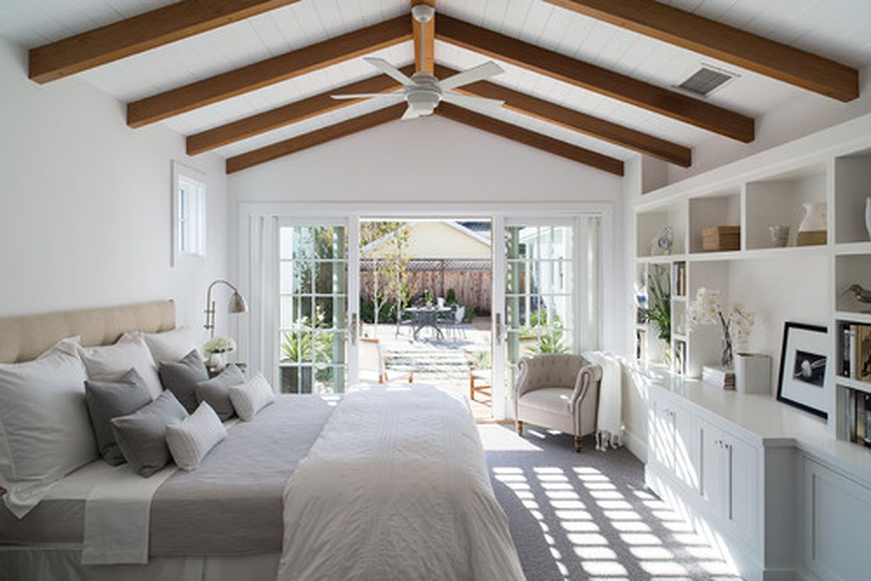 White bedroom with white bed, white pillow, and white wooden cabinet storage to look good