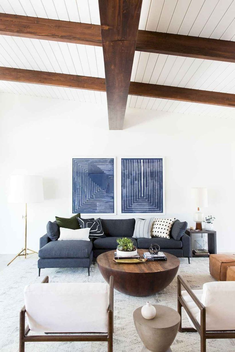 White living room combine white dark gray letter l sofa, round wooden table, white wooden sofa chairs to look confertable