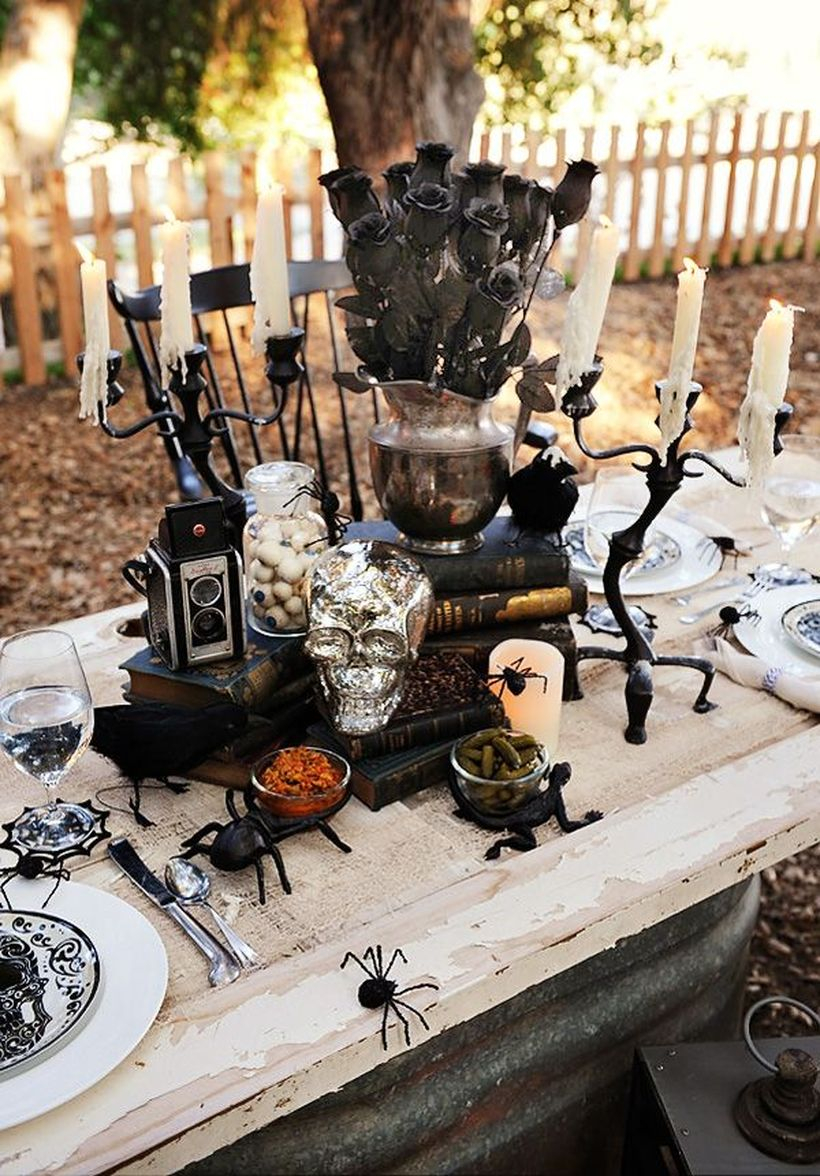 Black rose, iron black candle holder and black spider on dining table