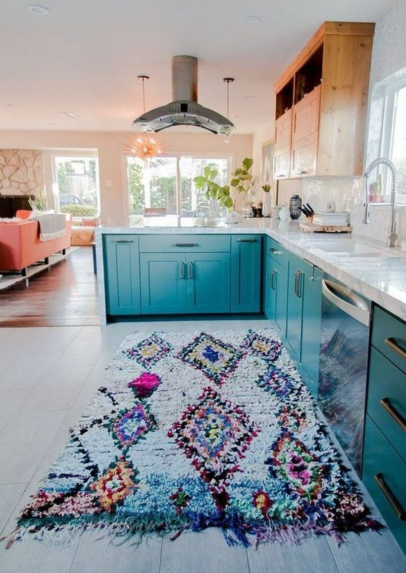 Boho pattern flooring in light blue color with blue wooden cabinet and white sink