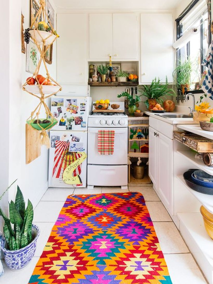 Boho pattern kitchen flooring with white cabinet, unique hanging storage and small pants on the pot