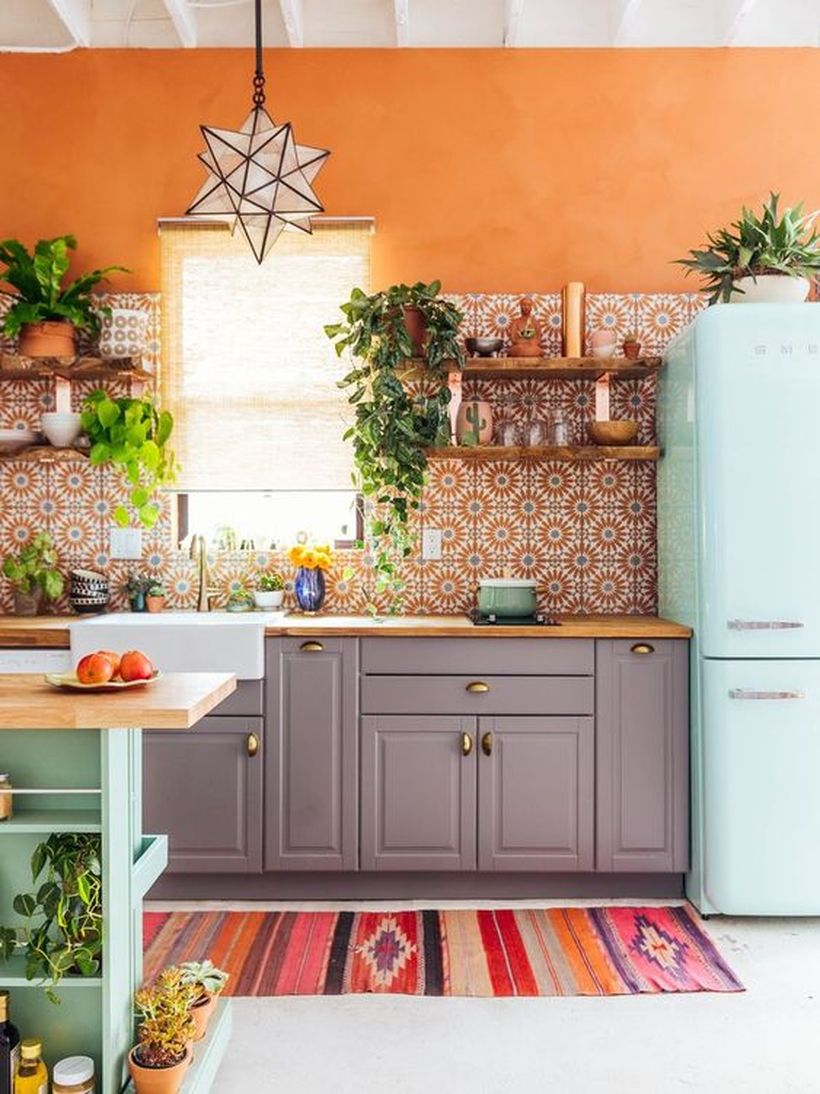 Colorful boho pattern flooring with gray wooden cabinet, wooden rack on the wall and small green plants