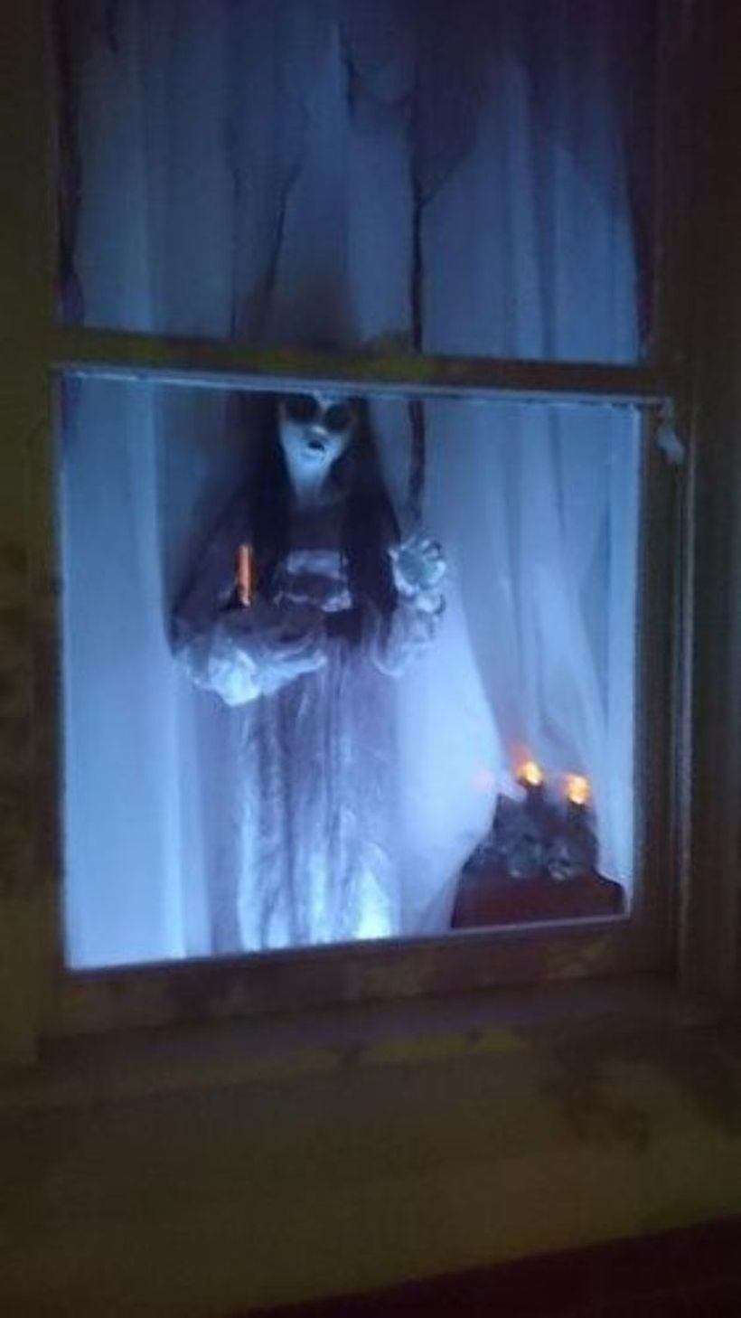 Creative ghost in the window for halloween decoration