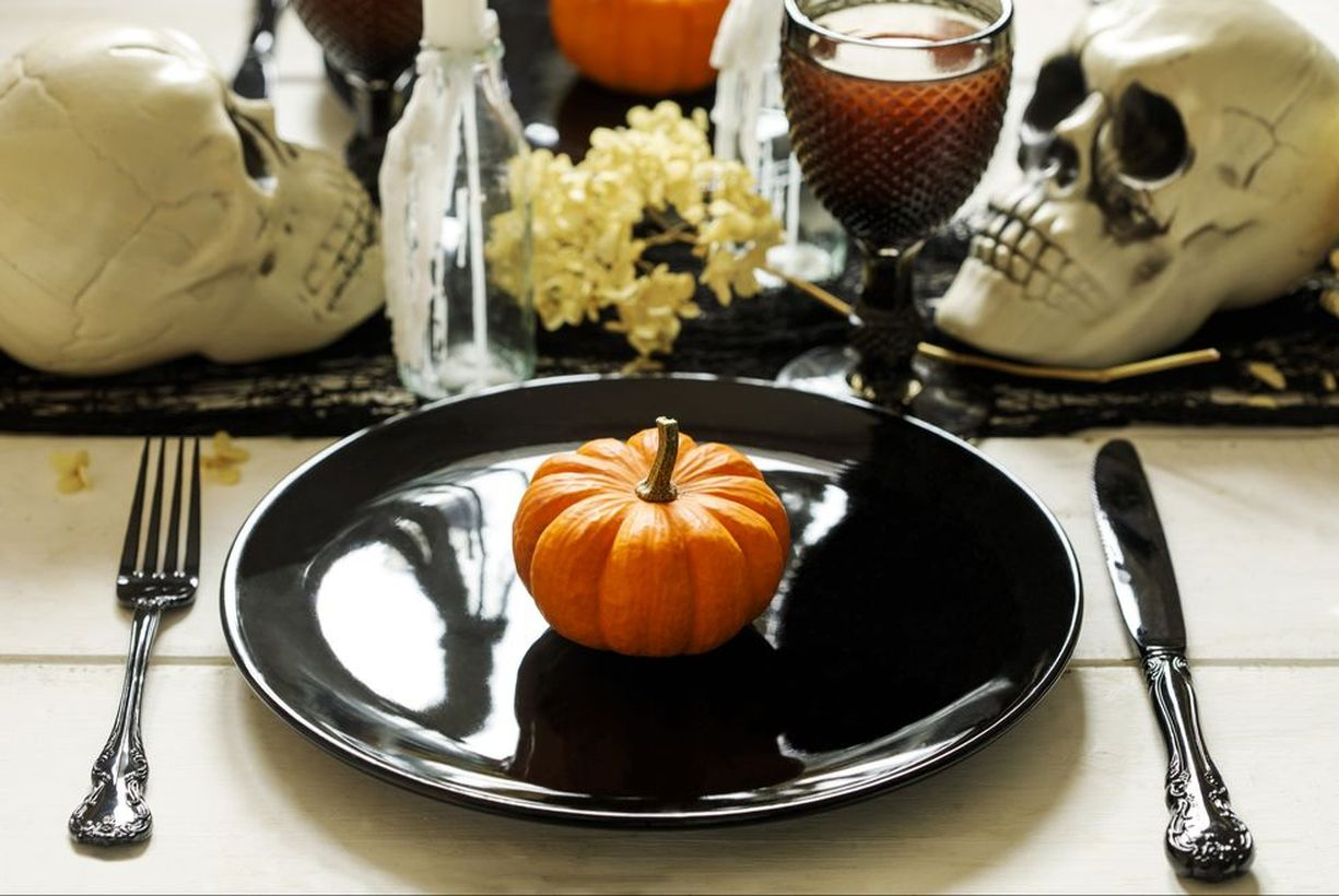 Halloween table decoration with skulls and pumpkin