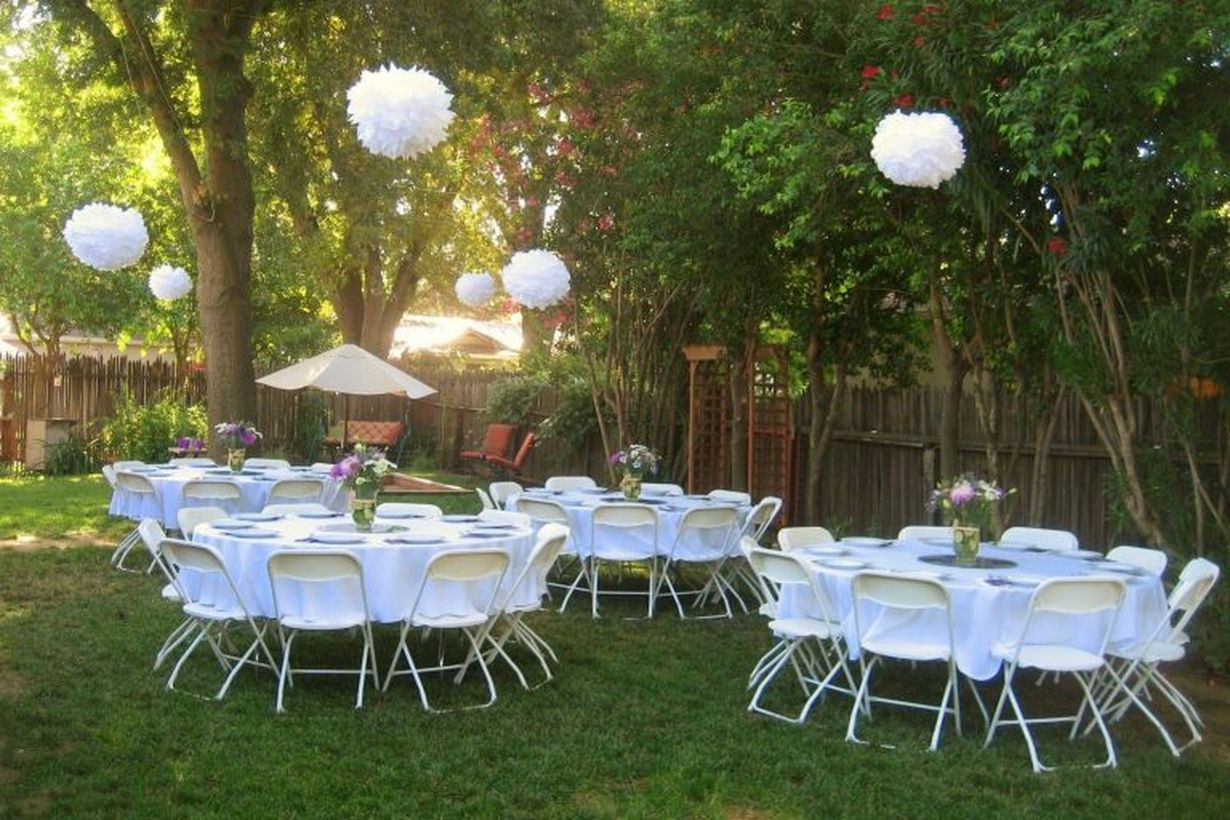Hanging raound white lamps and white table and chairs decoration