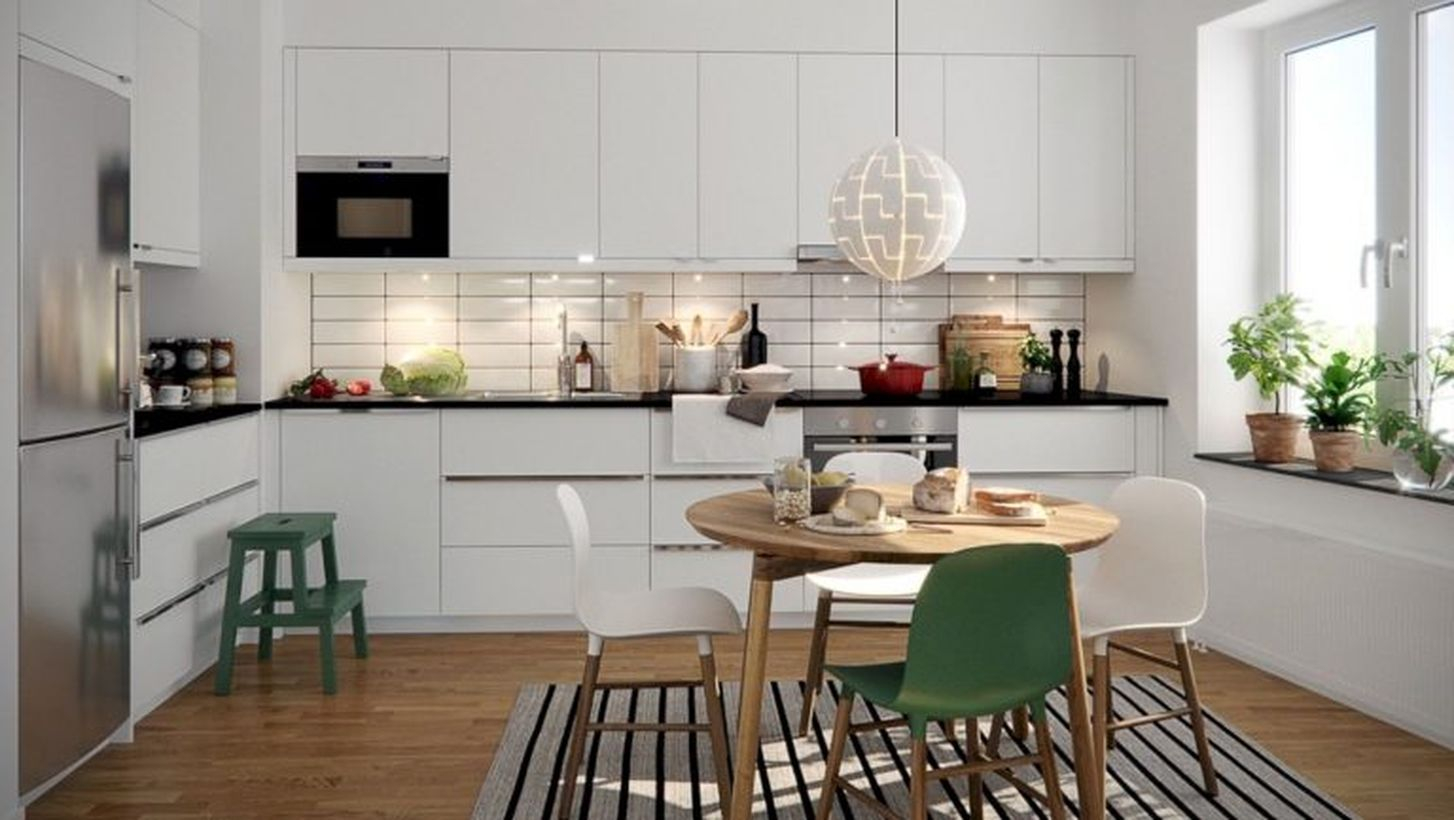 Scandinavian brown kitchen flooring with white cabinet, round wooden table and white black stripped carpet