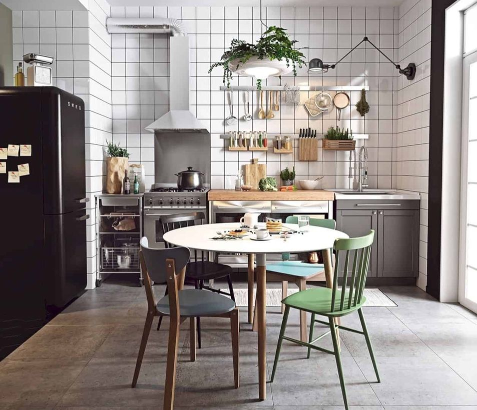 Scandinavian gray kitchen flooring with gray cabinet, round white table and green chairs