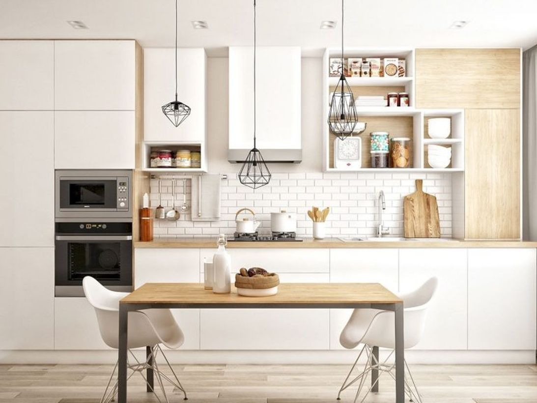 Scandinavianwhite wooden kitchen with white cabinet, square wooden table, white chairs and unique black hanging lamps