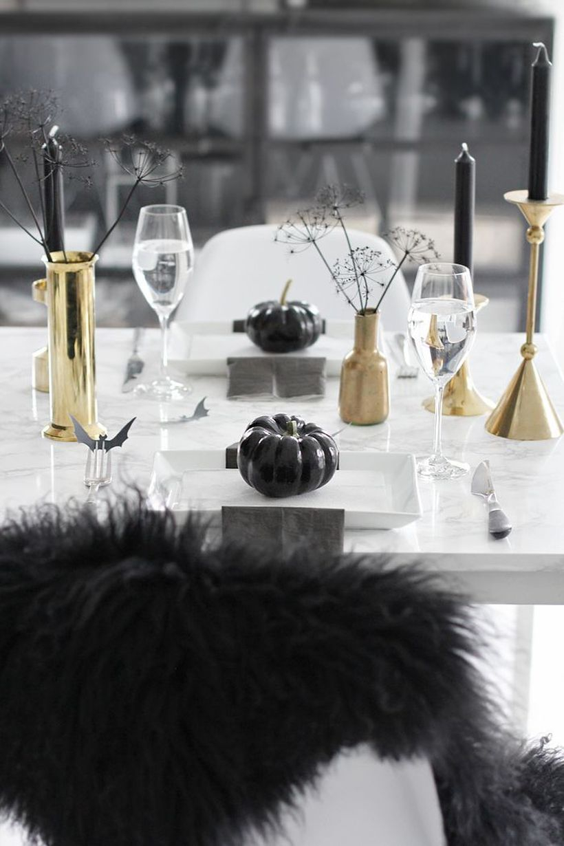 Scary halloween dining table with gold vases and candle holder
