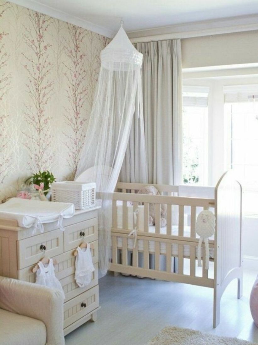 Simple-and-neat-baby-girls-nursery-room-with-wooden-white-bed-and-storage-baby-mosquito-nets-to-protect-your-baby-while-sleeping