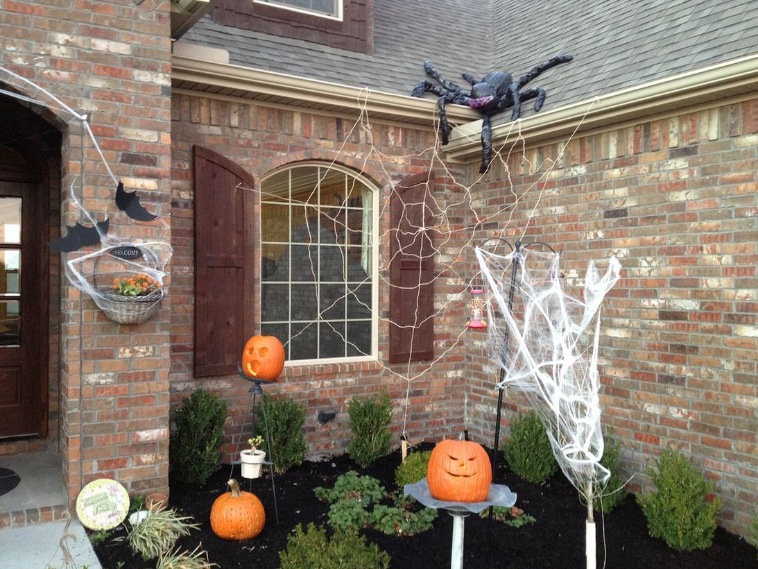 Simple outdoor halloween decoration with pumpkin and spider webs