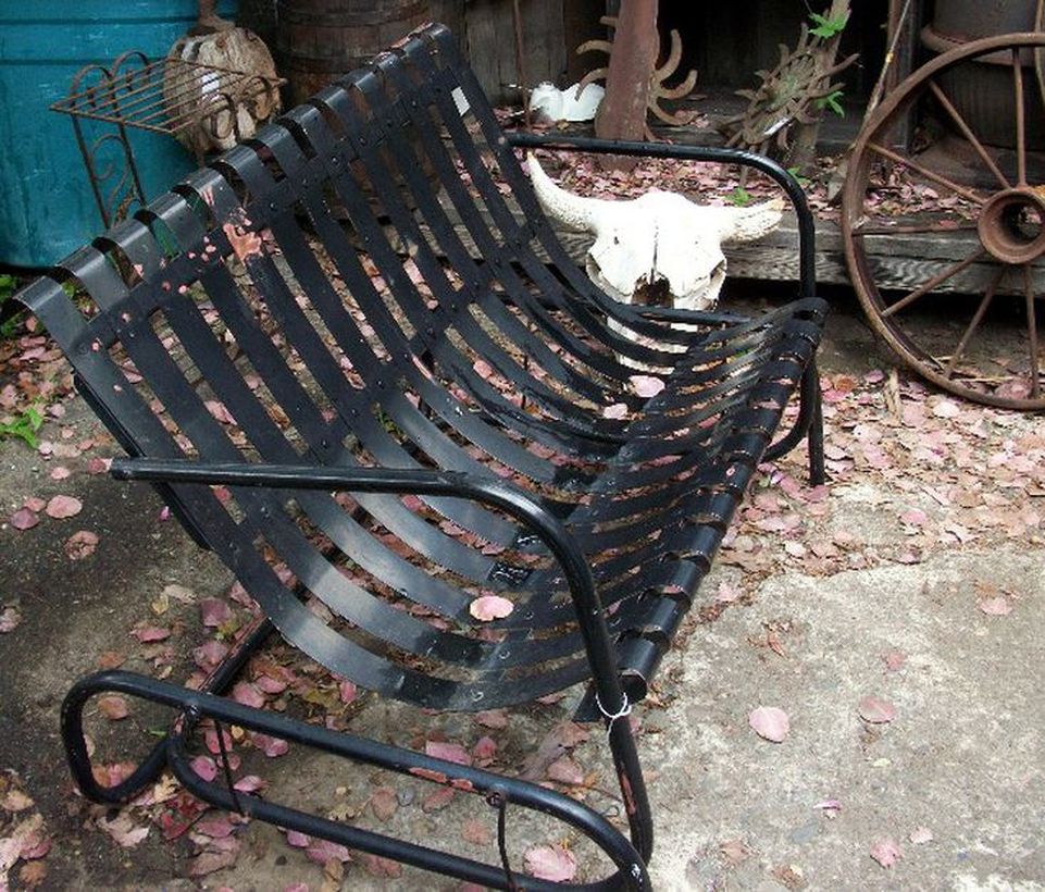 Simple-vintage-outdoor-furniture-with-black-glider-chair-can-be-used-for-two-people