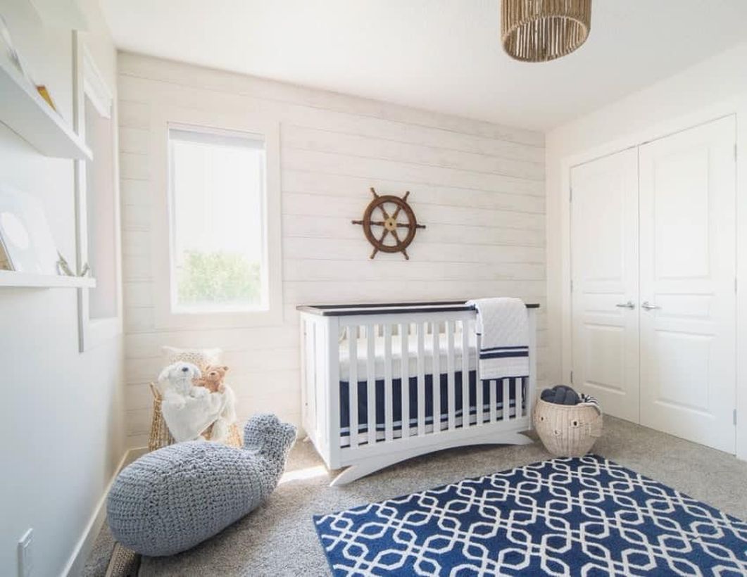 Unique-nursery-for-baby-boys-with-a-sea-theme-white-wooden-pallet-wall-and-big-shark-knit-doll