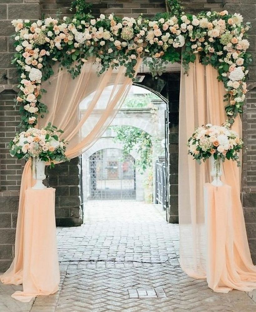 Wedding entrance decorations with white curtain and floral decoration
