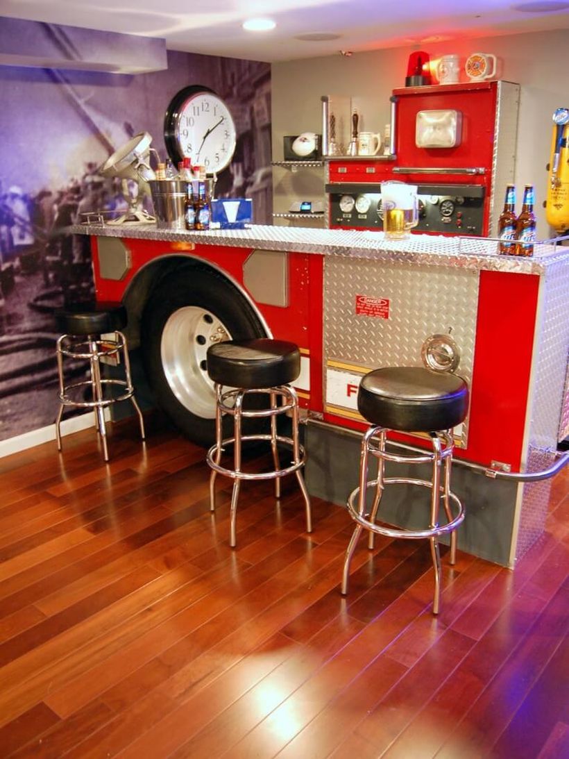 Car-shaped coffee bar made of red white metal and a small black sofa that looks cool