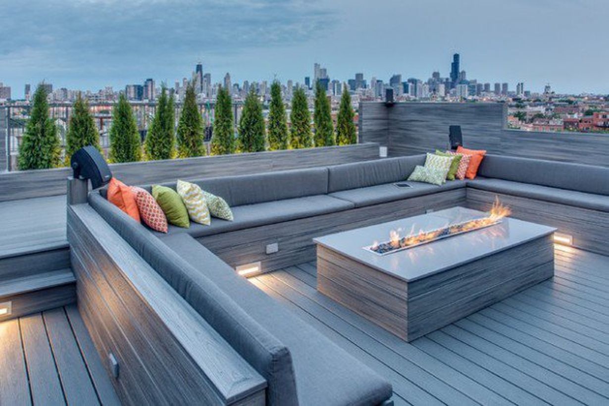 Elegant-fire-pit-on-a-big-table-and-long-sofa-to-relax-with-family-and-as-warmers-on-your-roof-top