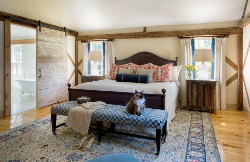 Farmhouse-bedroom-with-much-weathered-and-aged-wood-traditional-textiles.-1