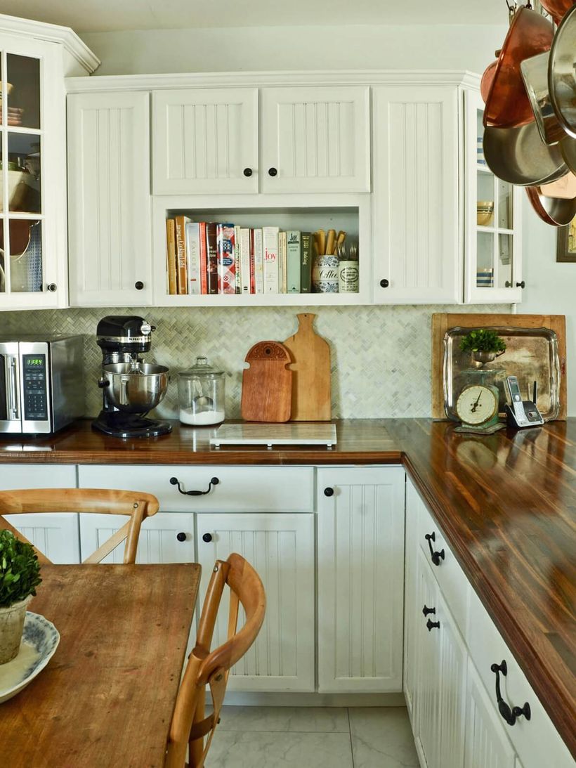 L-shaped-wooden-countertop-with-white-kitchen-cabinet